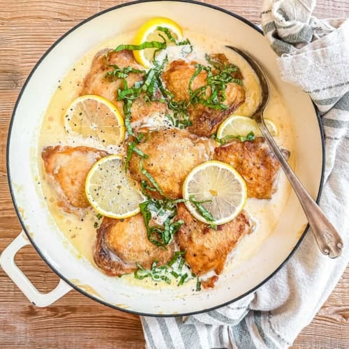 creamy lemon basil chicken in a braising pan.