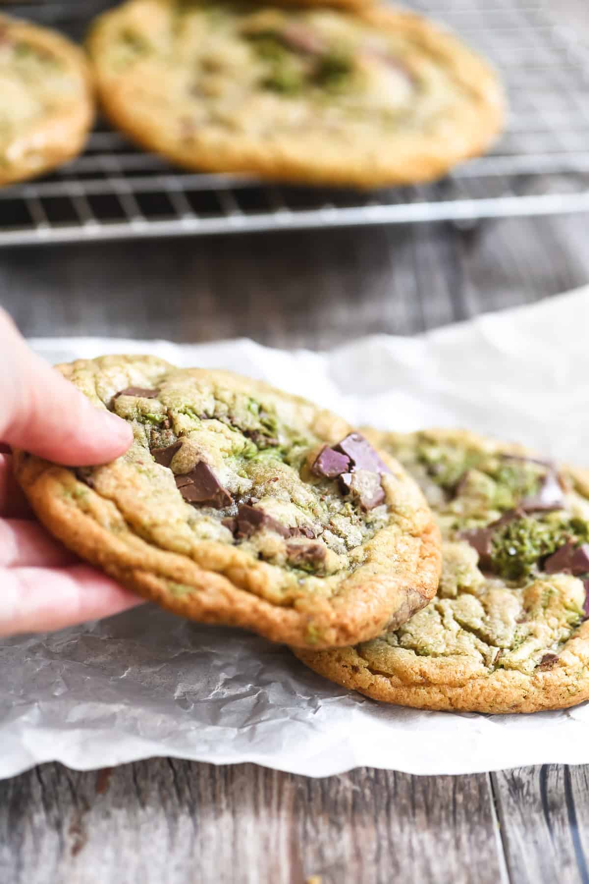Taking a Dubai chocolate chip cookie from parchment paper.