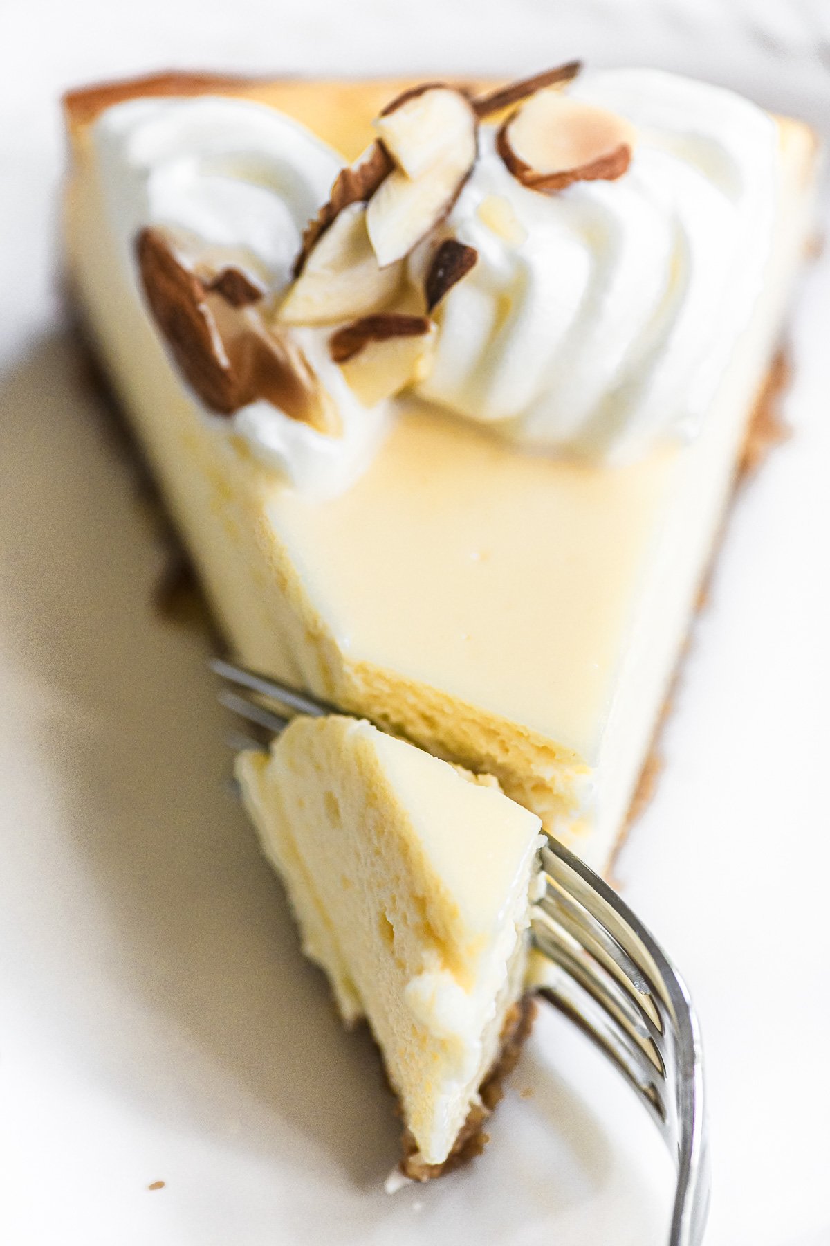 taking a bite of almond cheesecake.