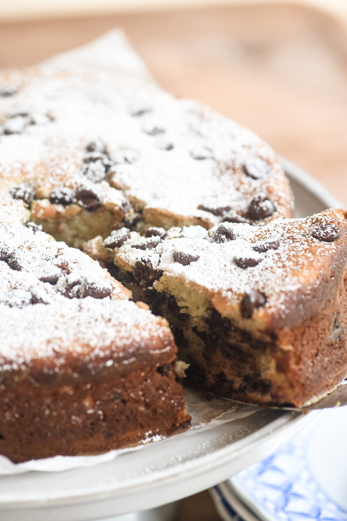 Taking a slice of chocolate chip ricotta cake.