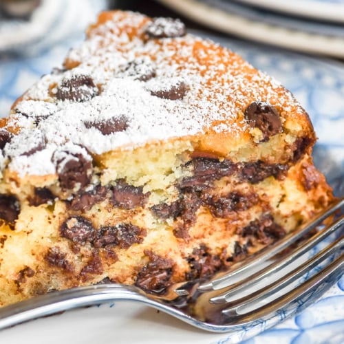 a slice of chocolate chip ricotta cake on a plate.
