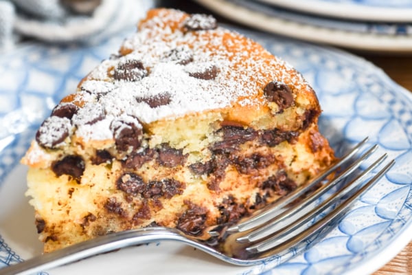 a slice of chocolate chip ricotta cake on a plate.