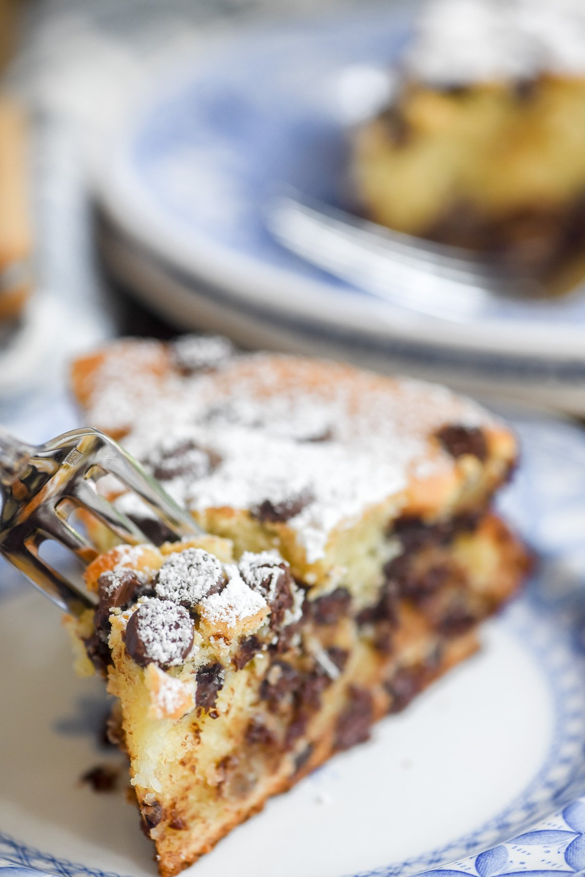 a slice of chocolate chip ricotta cake with fork in it,