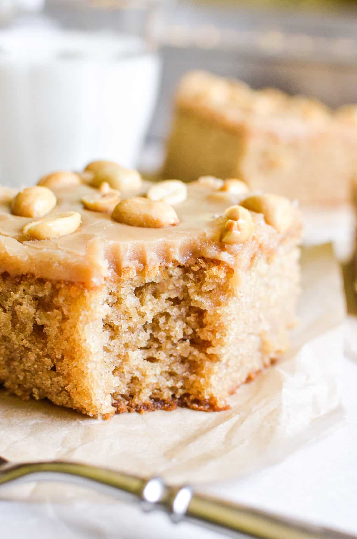 A slice of gluten free peanut butter cake with a bite taken out.