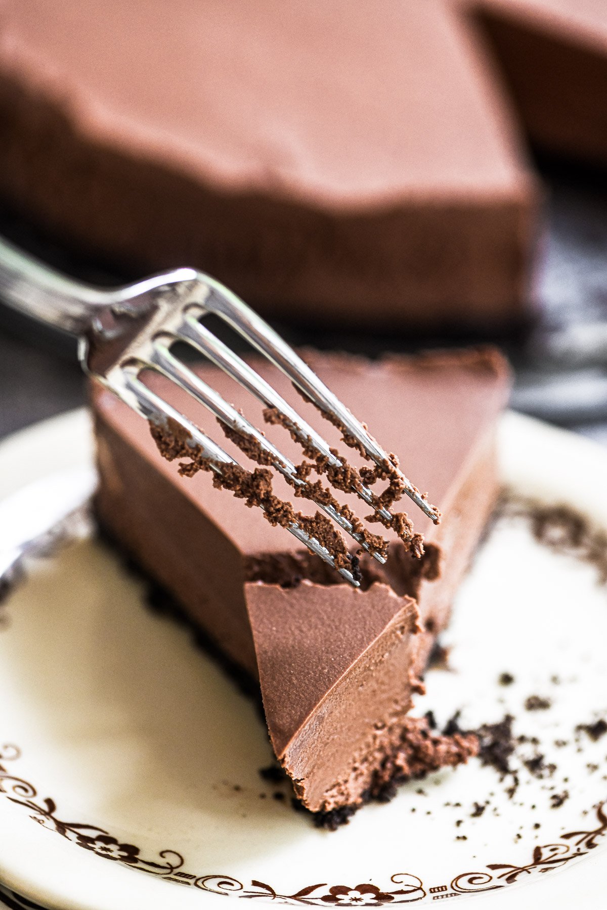 No bake chocolate cheesecake, with fork taking a bite.