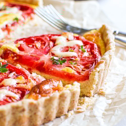 Taking a slice of a tomato tart.