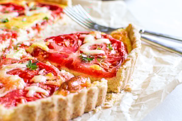 Taking a slice of a tomato tart.