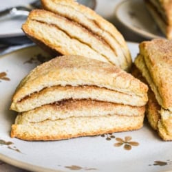 layered cinnamon scones on a plate.