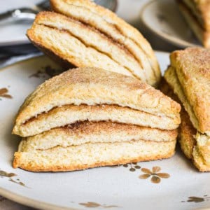 layered cinnamon scones on a plate.
