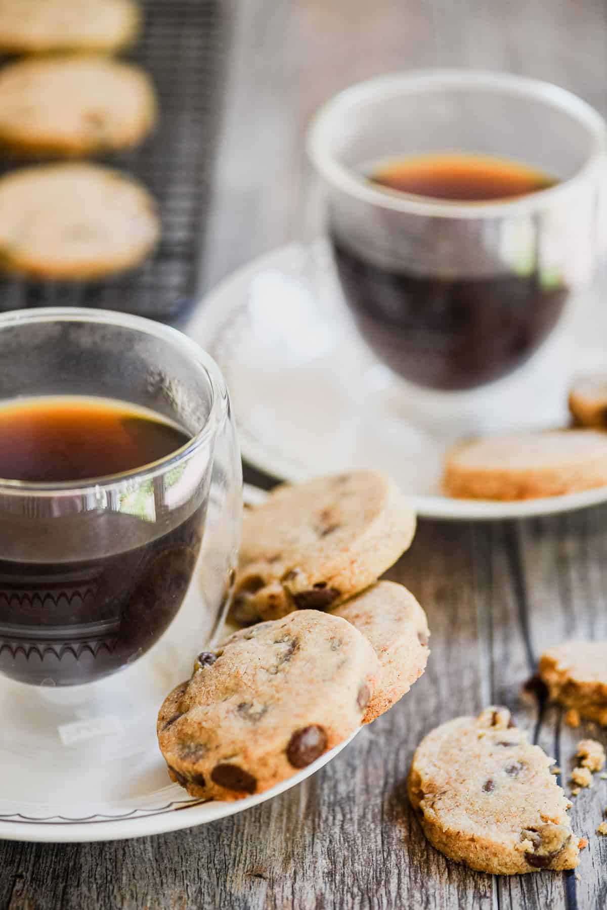 espresso chocolate chip shortbread cookies with cups of coffee.