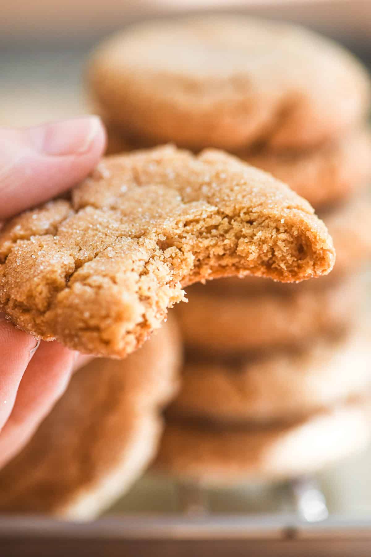 taking a bite out of a 3 ingredient peanut butter cookie.