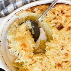 Grated potato casserole with a serving spoon