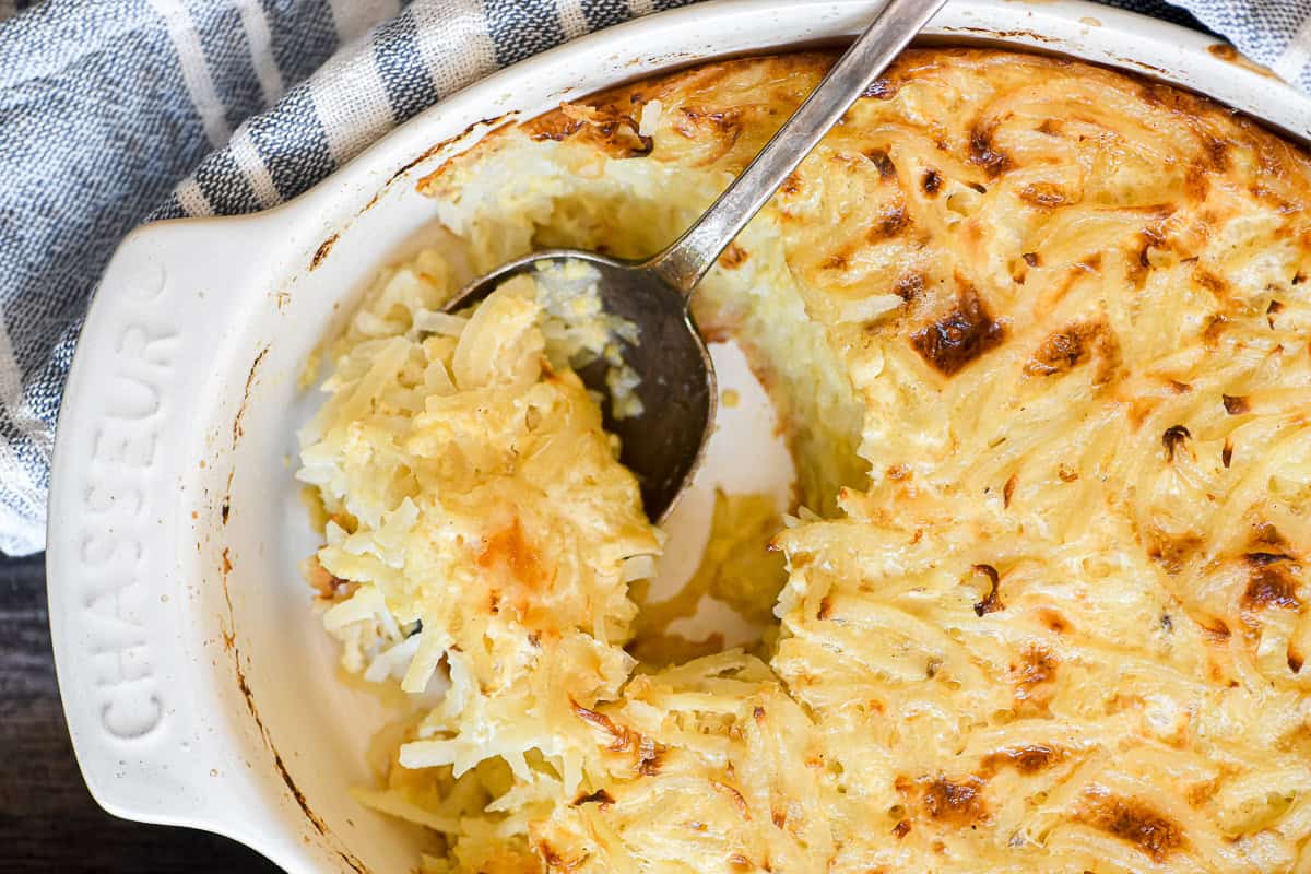 Grated potato casserole with a serving spoon
