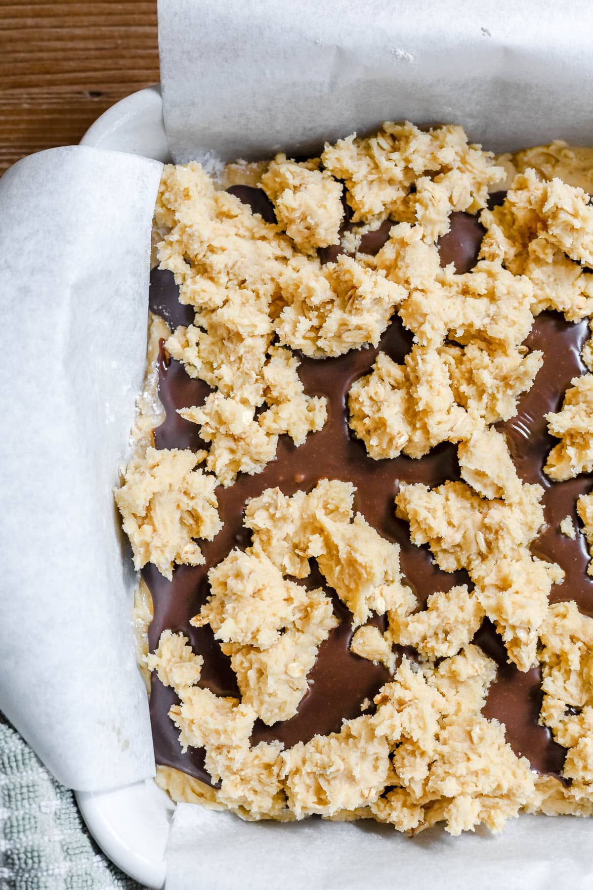 top crumble crust on oatmeal fudge bars before baking.