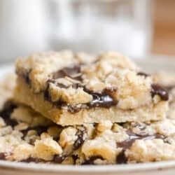a plate of oatmeal fudge bars with milk bottle.