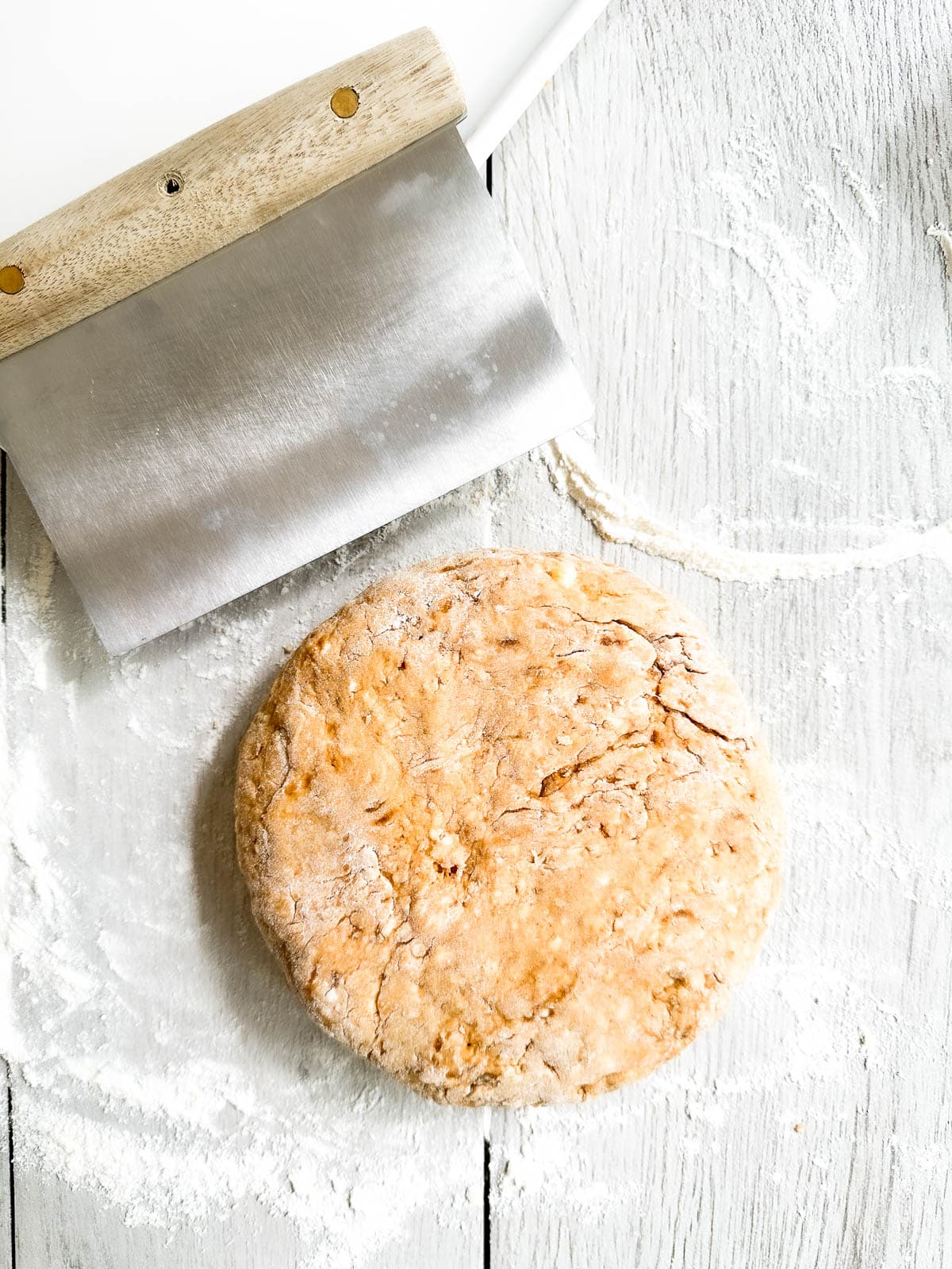 a disk of pumpkin scone dough ready to slice.