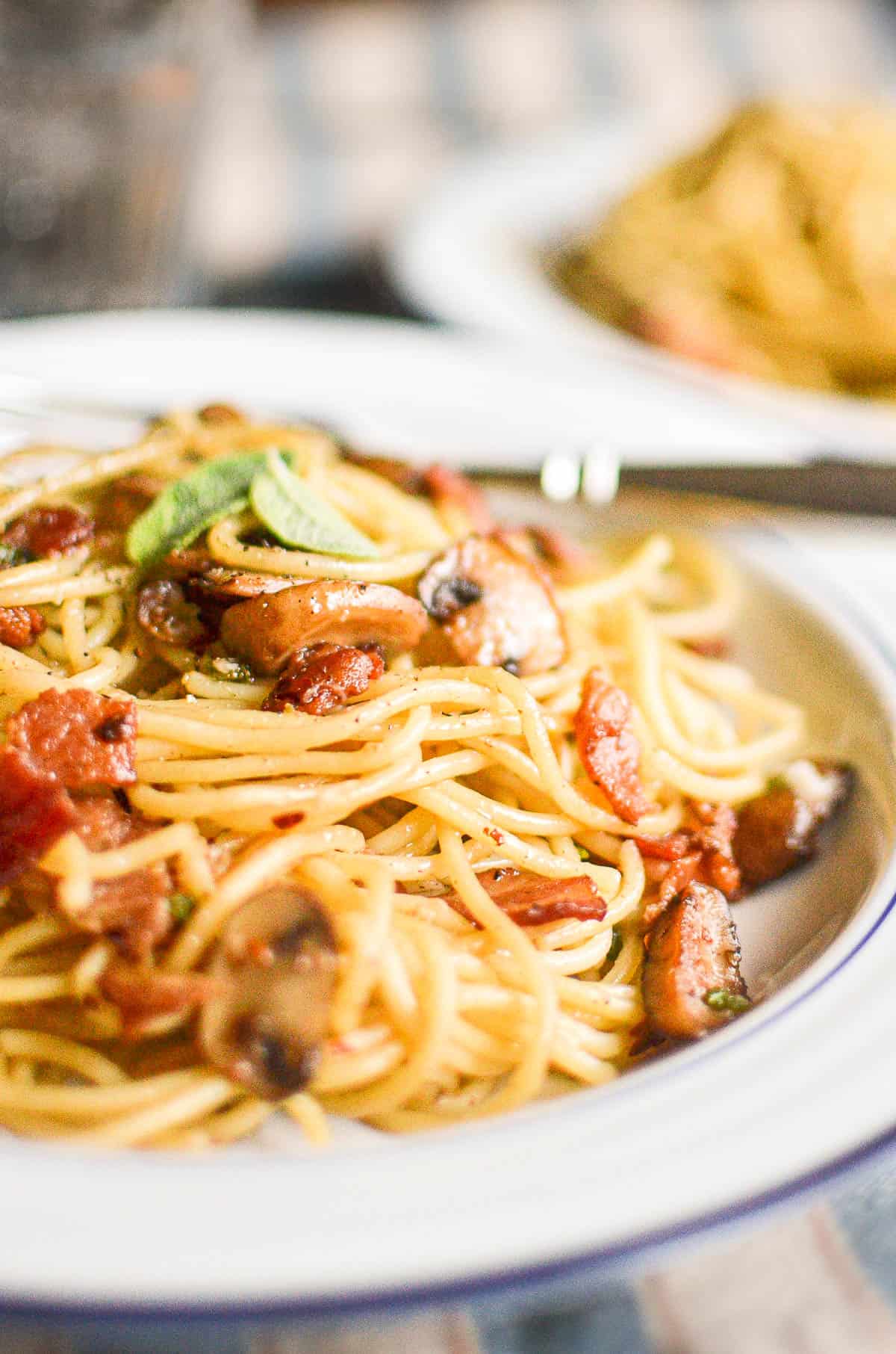 A fast and easy weeknight pasta made with hearty bacon and mushrooms tossed in a warm balsamic vinaigrette!