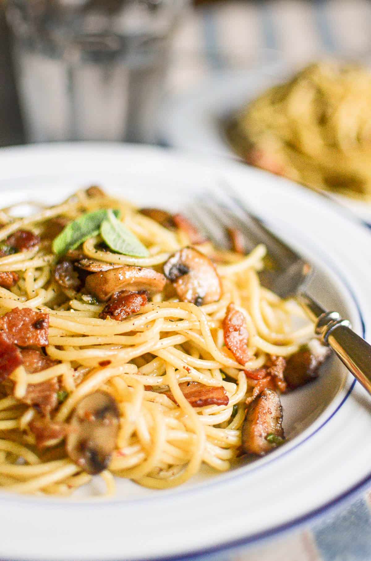 A fast and easy weeknight pasta made with hearty bacon and mushrooms tossed in a warm balsamic vinaigrette!