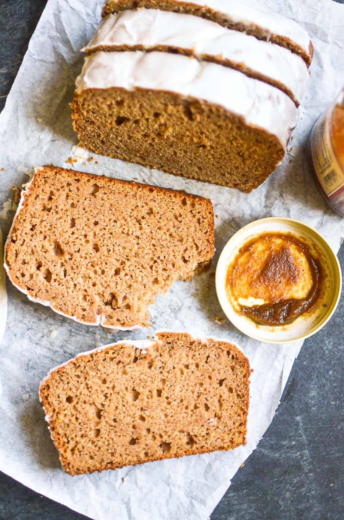 Slices of spiced apple cake on a piece of white parchment paper.