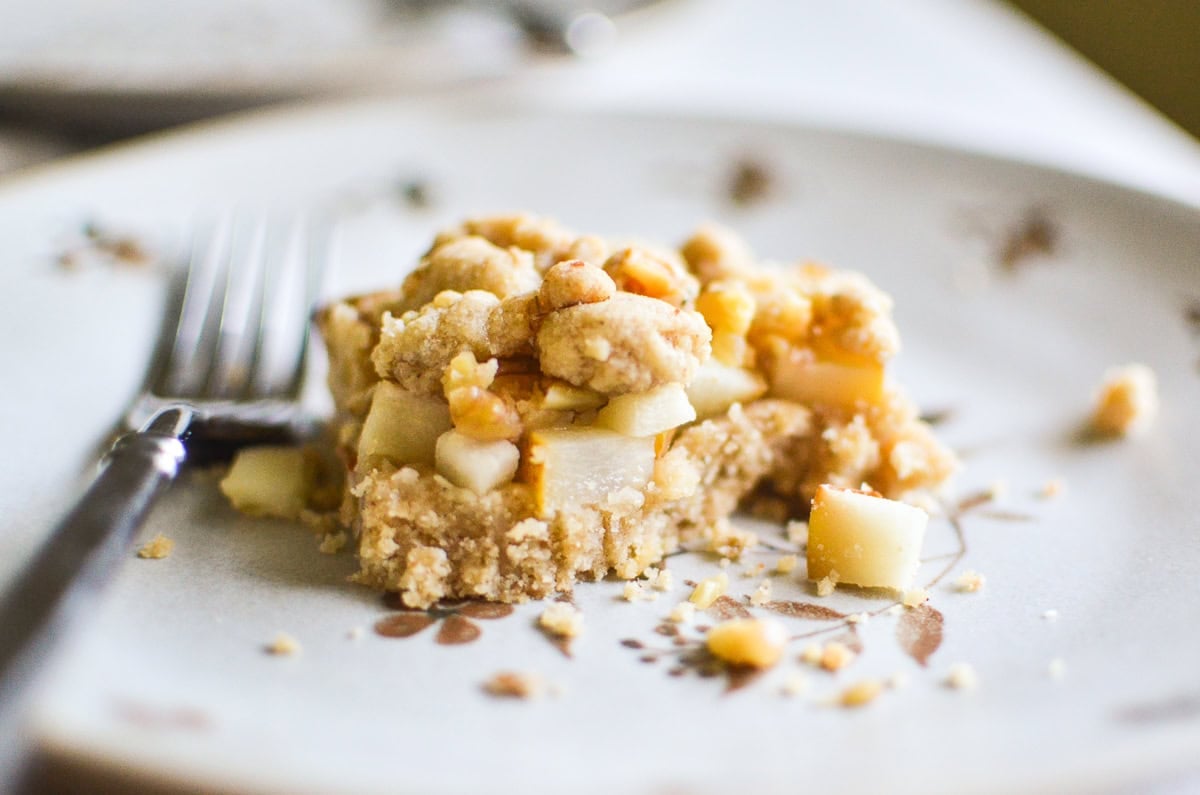 Pear crumble bar with a bite taken out.