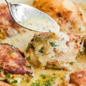 Spooning sauce over French mustard chicken thighs.
