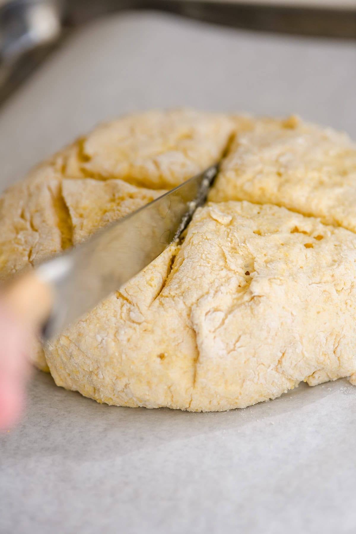 slicing a cross in Irish soda bread.