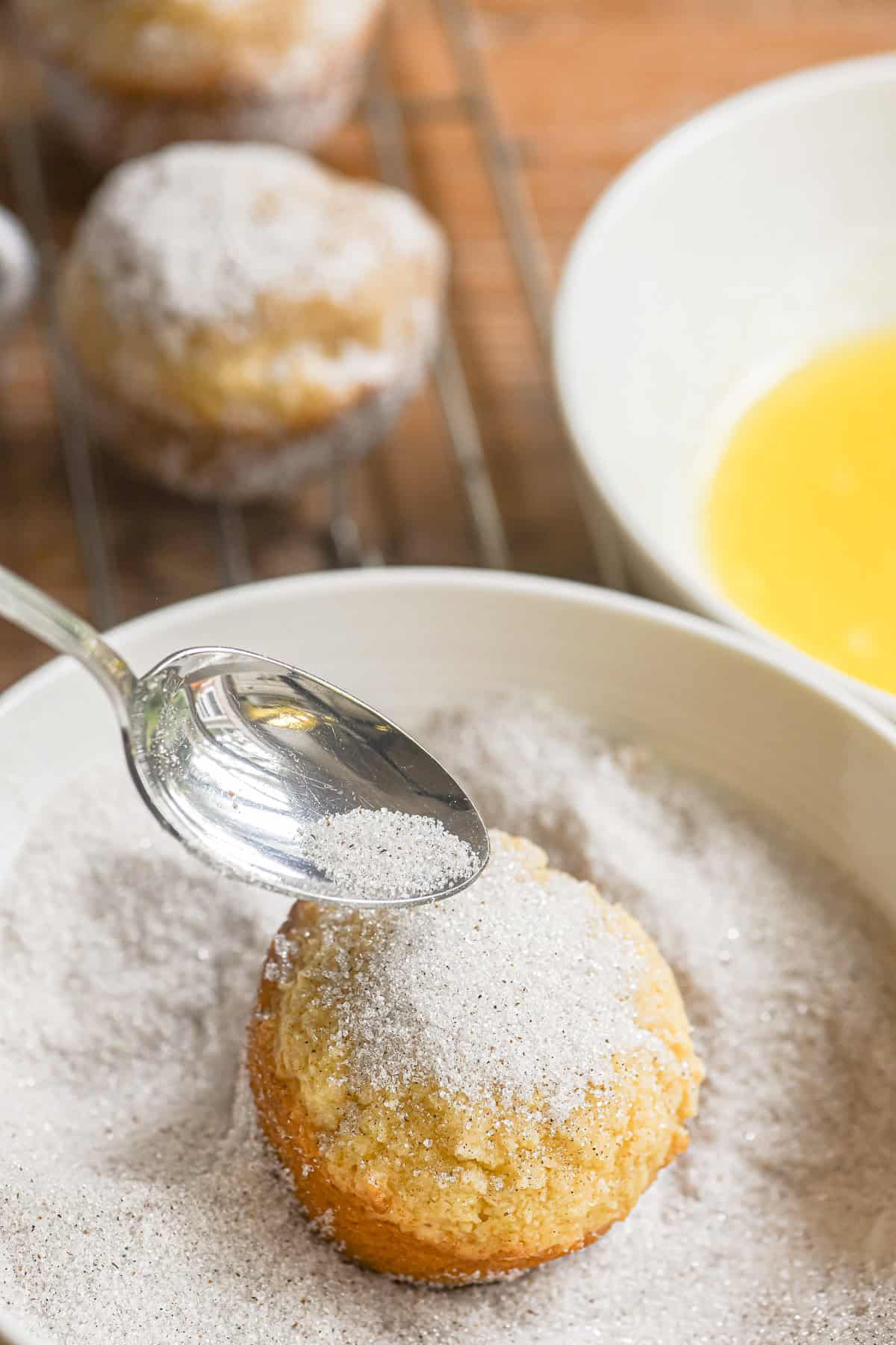 spooning cardamom sugar on Swedish breakfast buns.