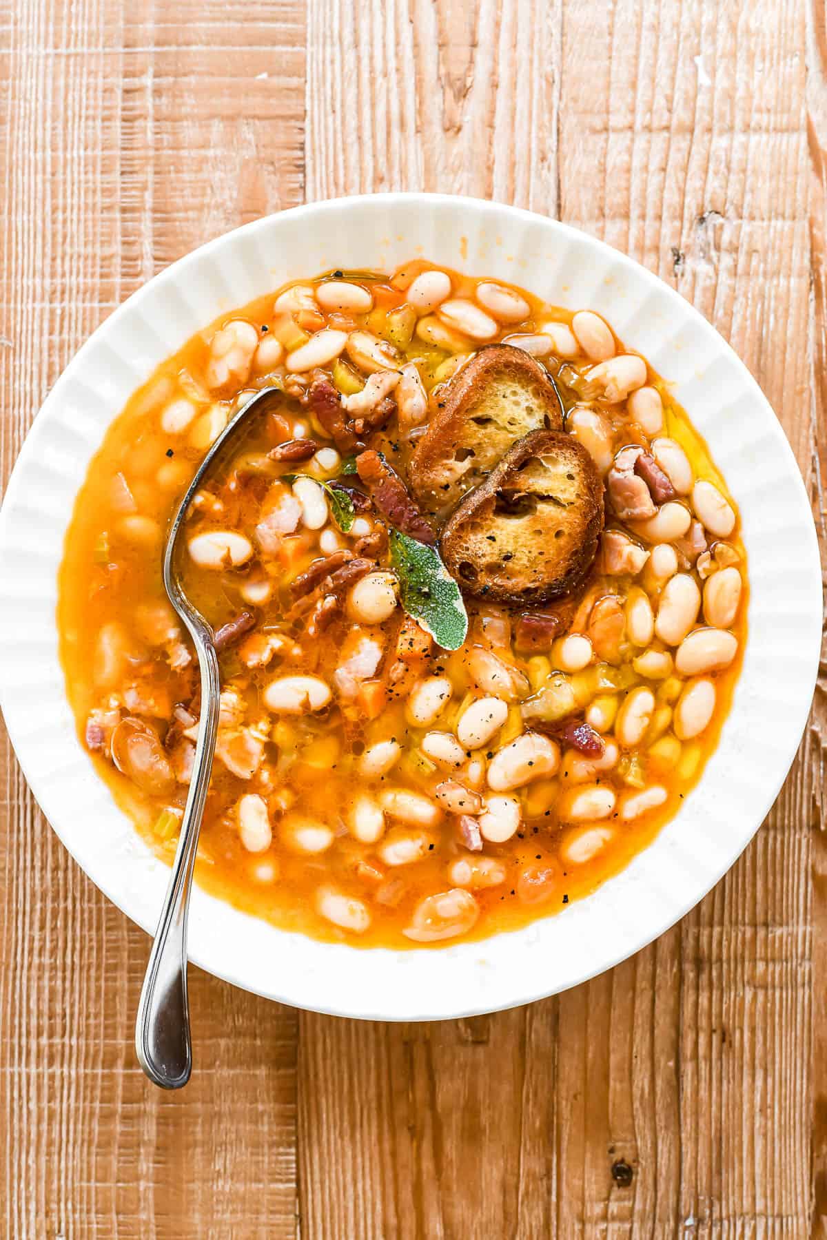a bowl of Tuscan white bean soup with bacon.
