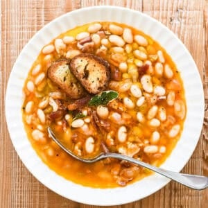 white bean and bacon soup with spoon.
