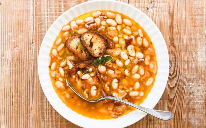 white bean and bacon soup with spoon.
