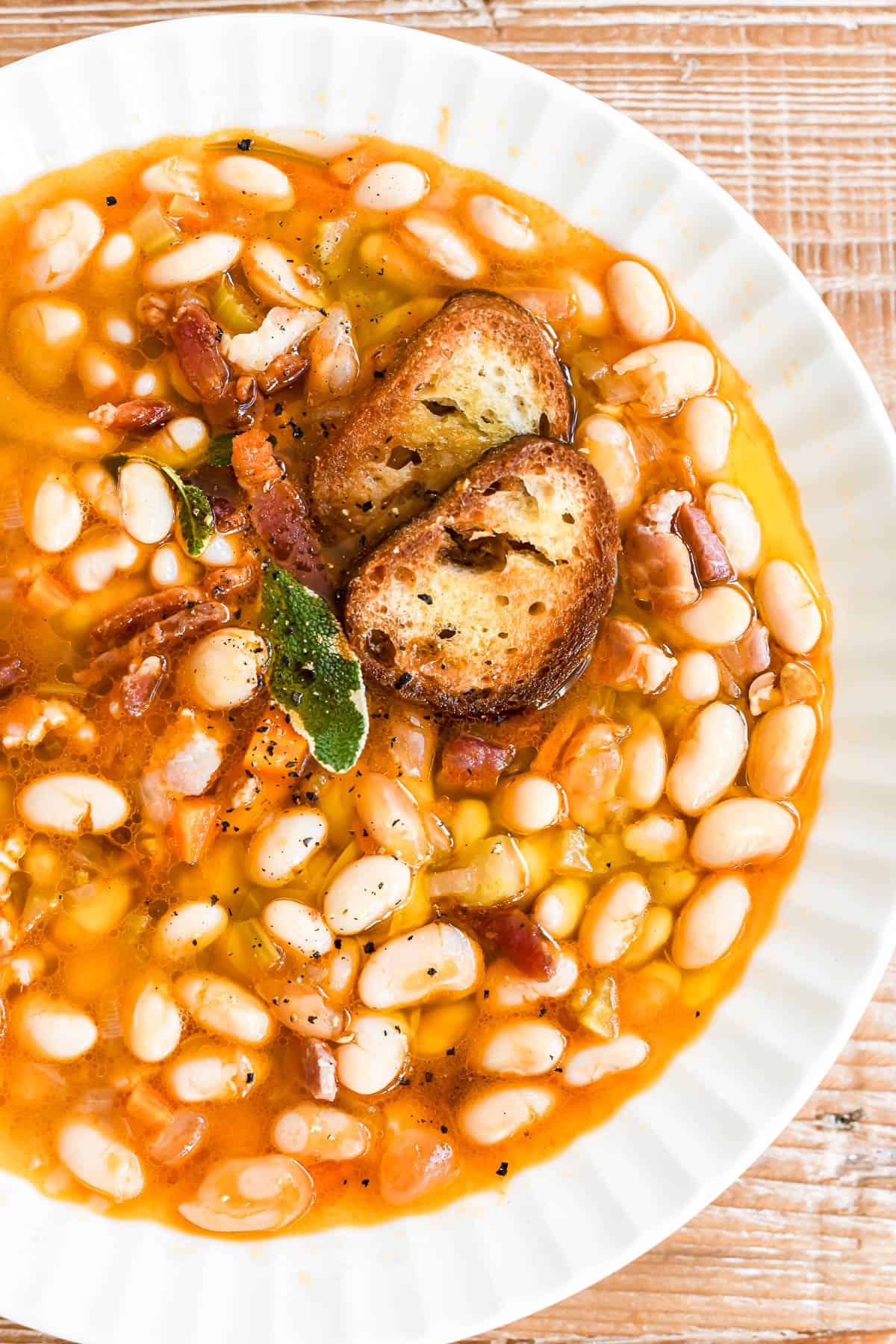 closeup texture of white bean and bacon soup.