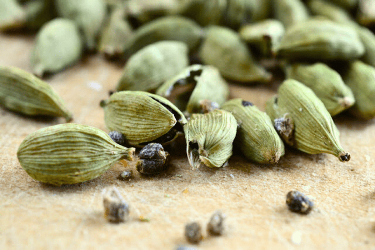 green cardamom pods with black cardamom seeds.