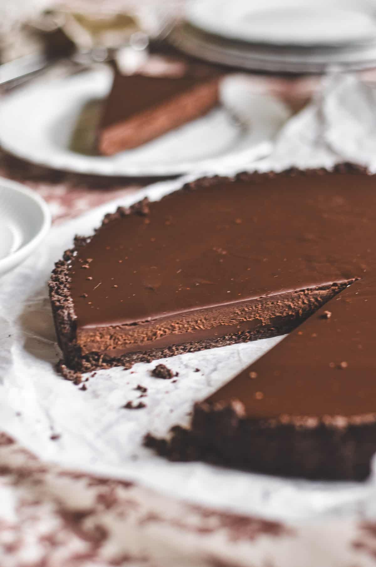 Espresso ganache tart with slice taken.
