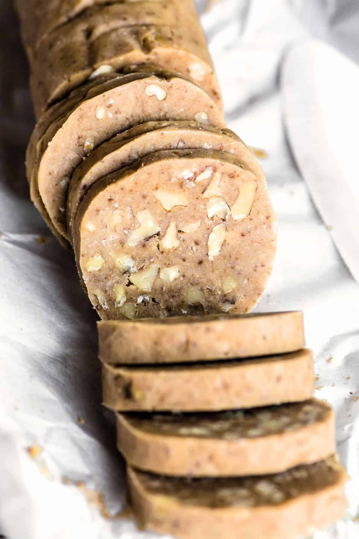 maple walnut shortbread cookie dough made into a log for slice and bake.