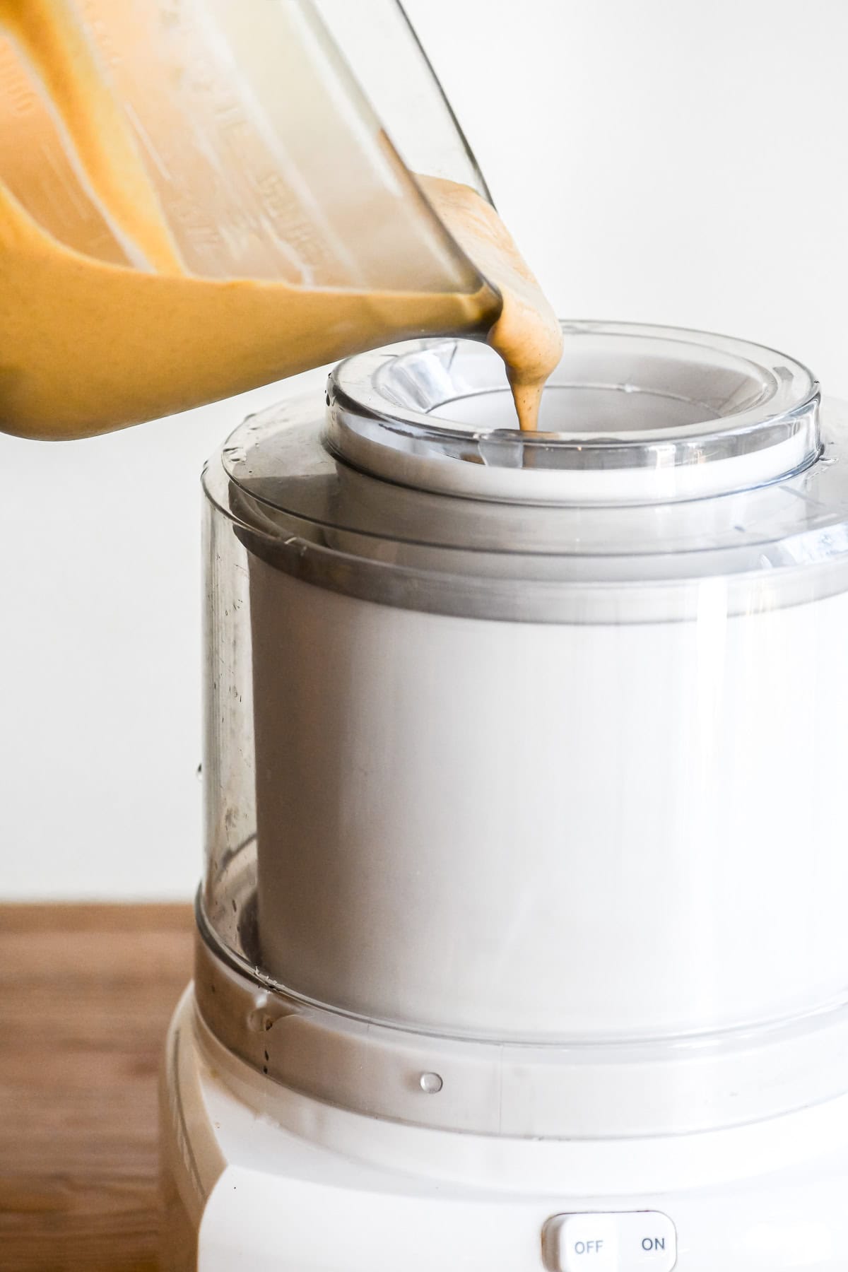 pouring pumpkin custard into ice cream machine.