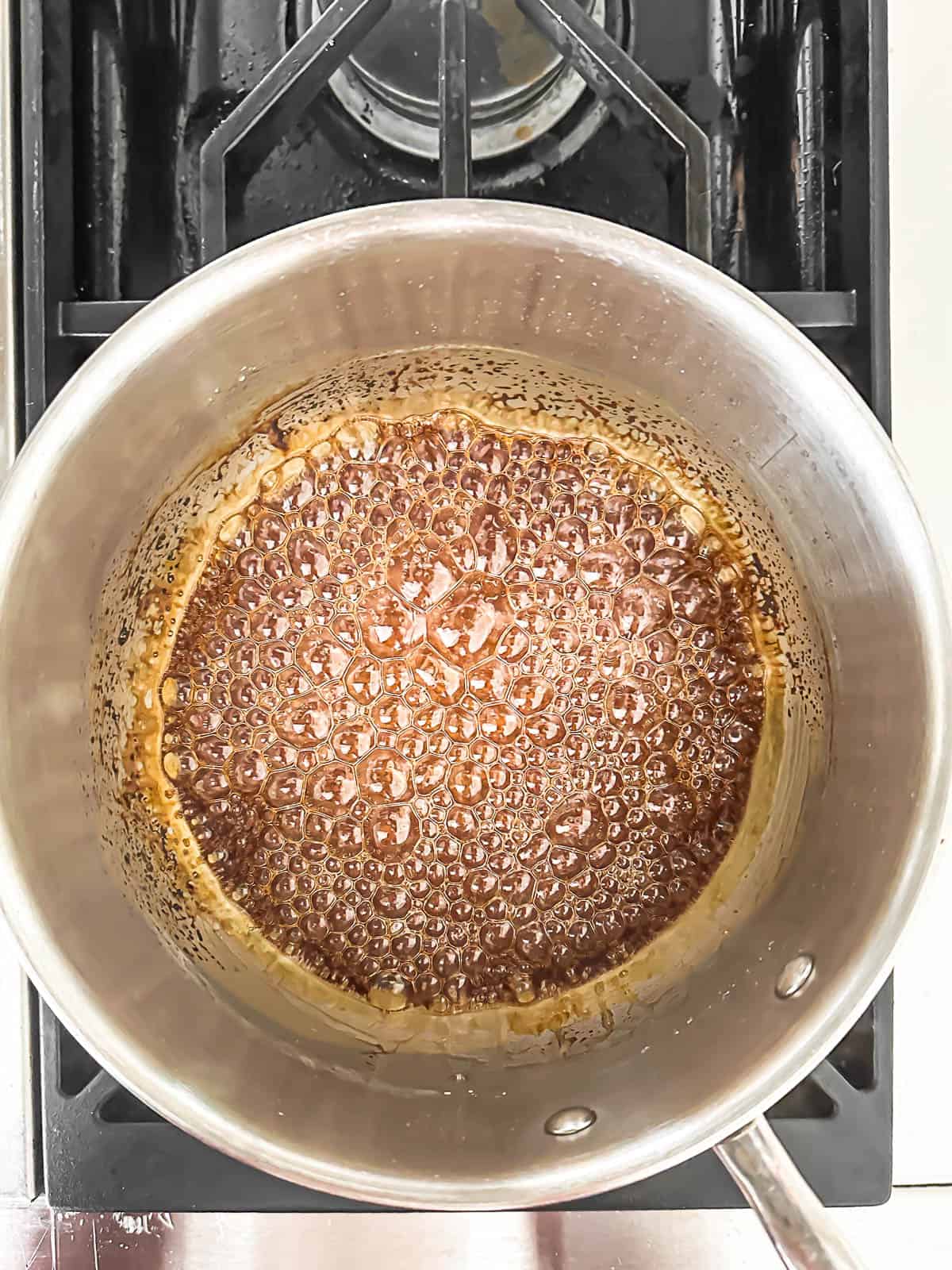 making caramel on the stove for salted caramel pot de creme.
