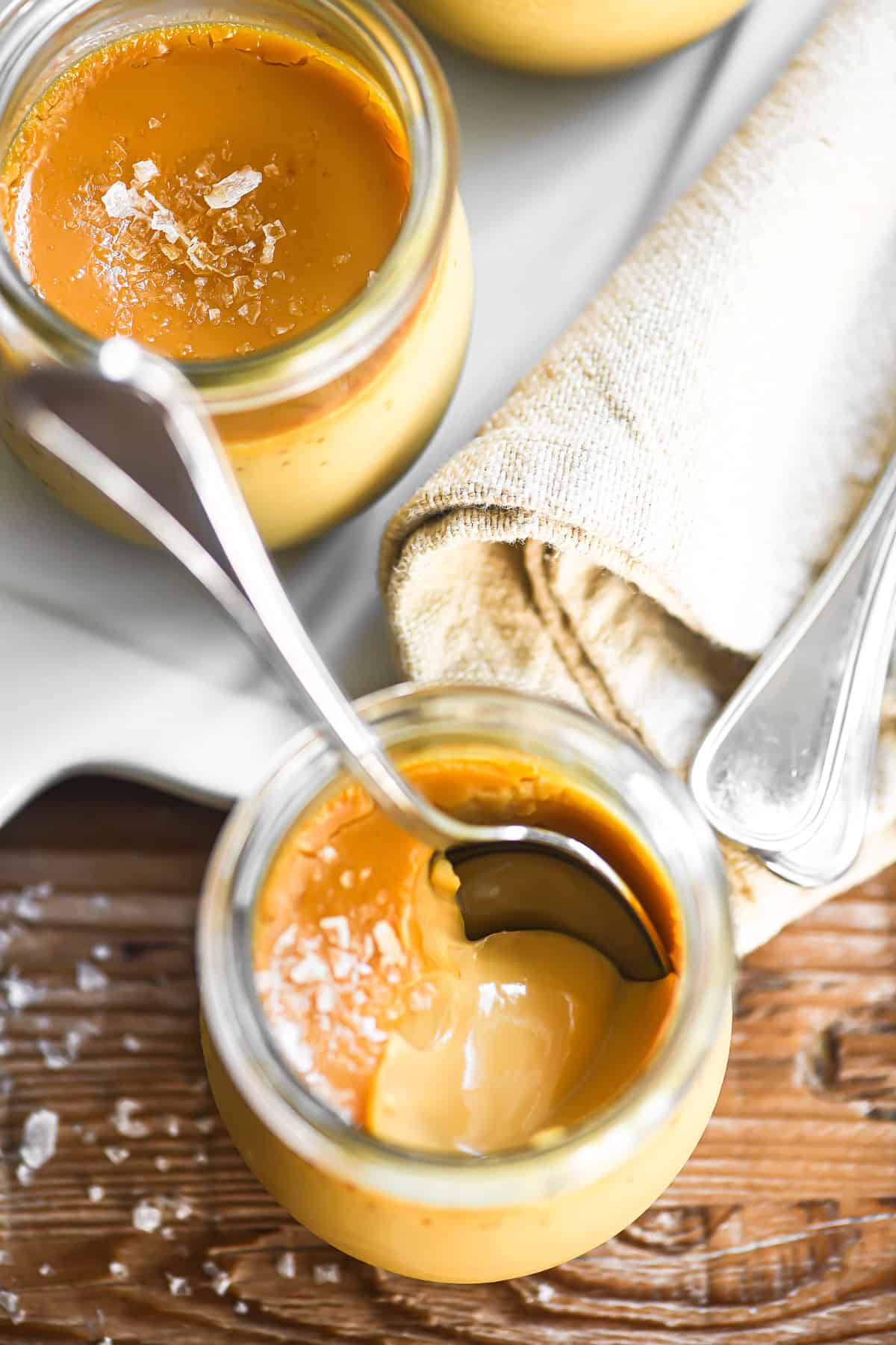 Taking a spoonful of salted caramel pot de creme.