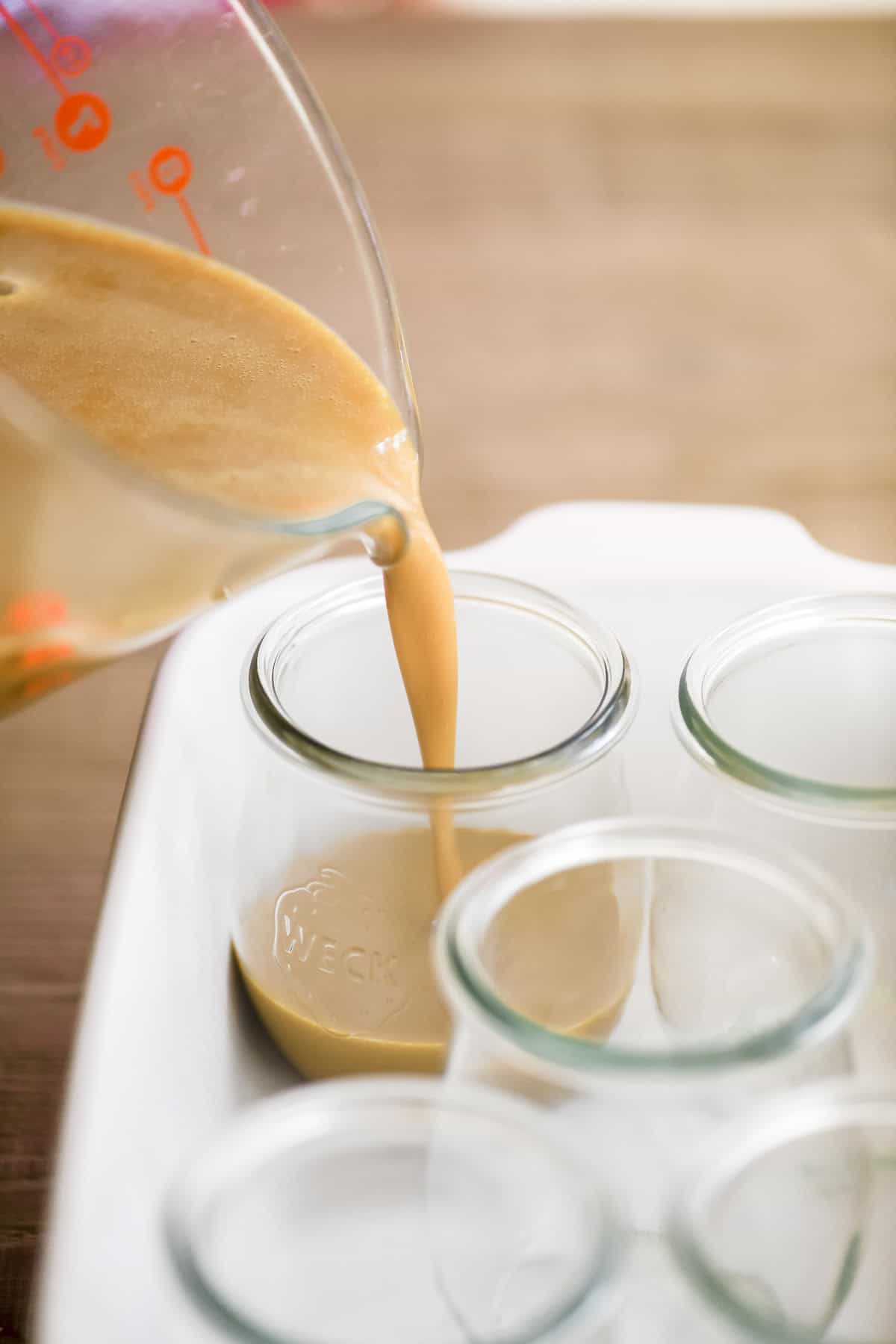 pouring salted caramel custard into Weck jars
