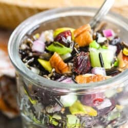 Wild rice salad with cranberries in a small jar.