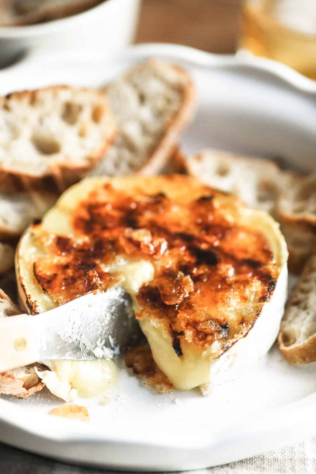 brûléed Brie in a white baking dish