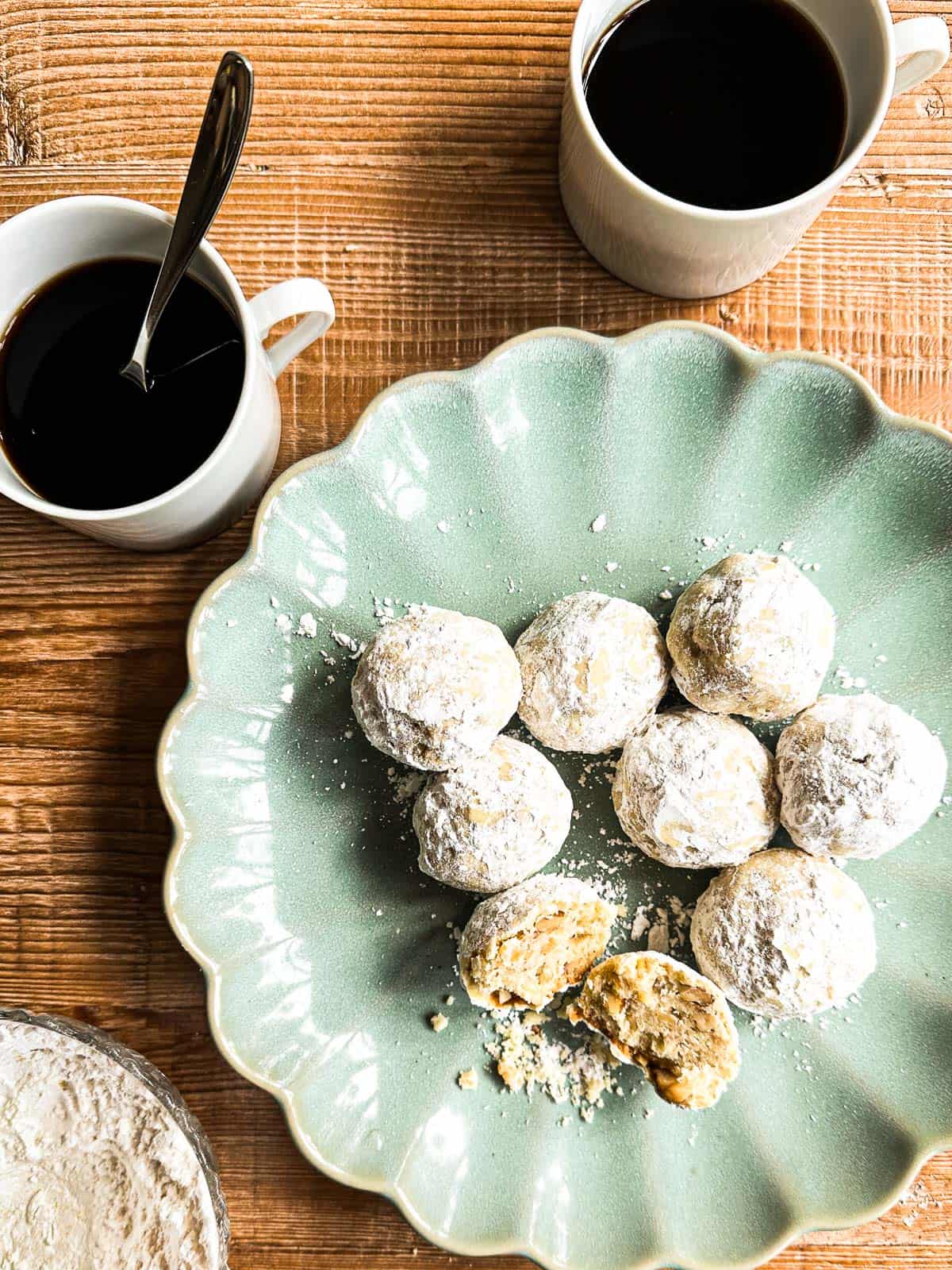 walnut ginger butter ball cookies on a green plate.