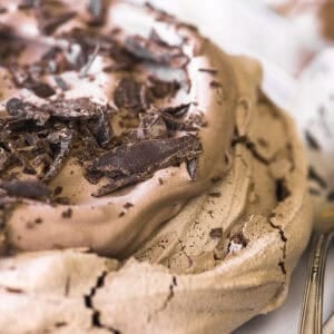 chocolate pavlova onn a cake stand.