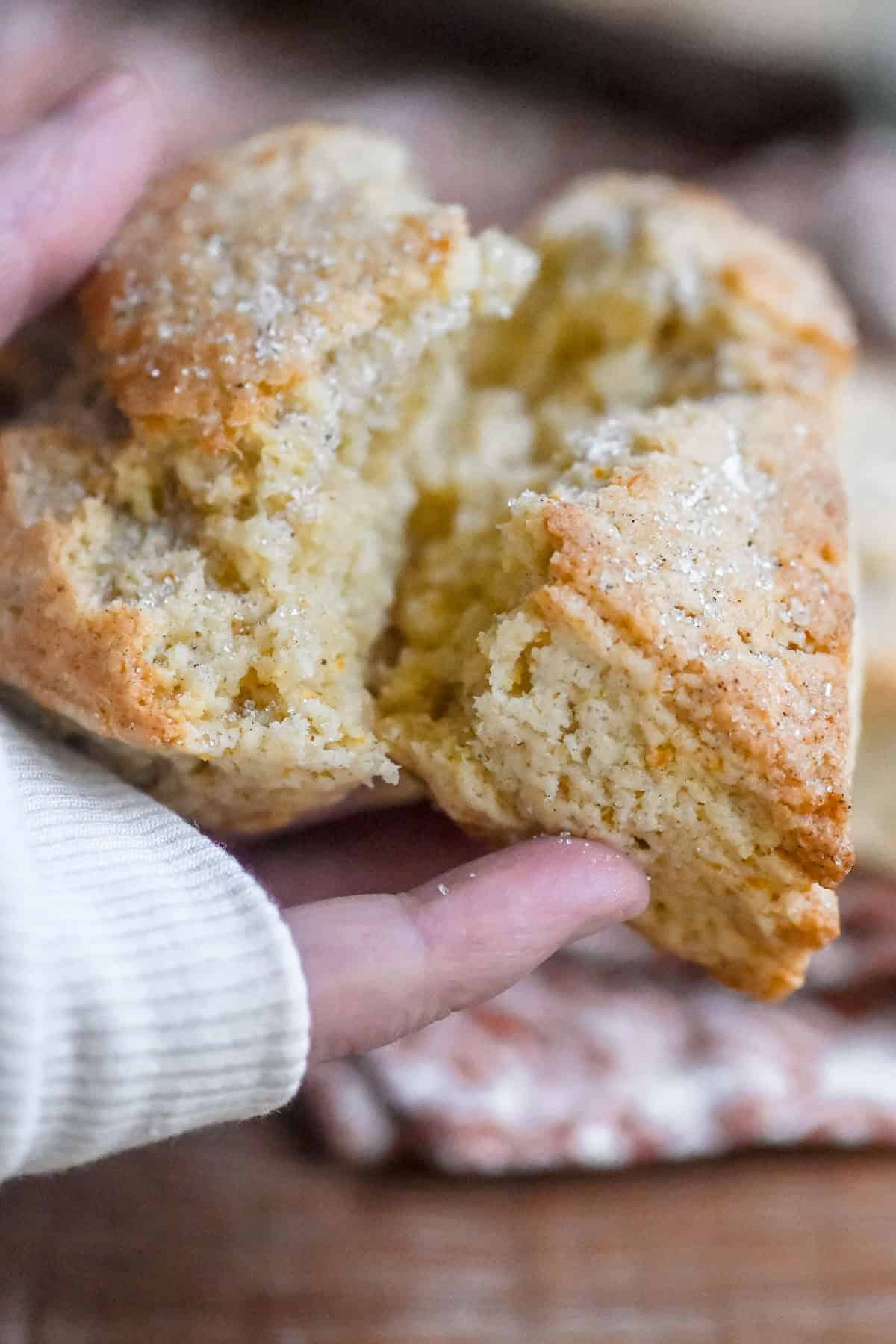 breaking open an orange cardamom scone.