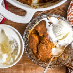 Pumpkin Indian Pudding in a bowl with ice cream.