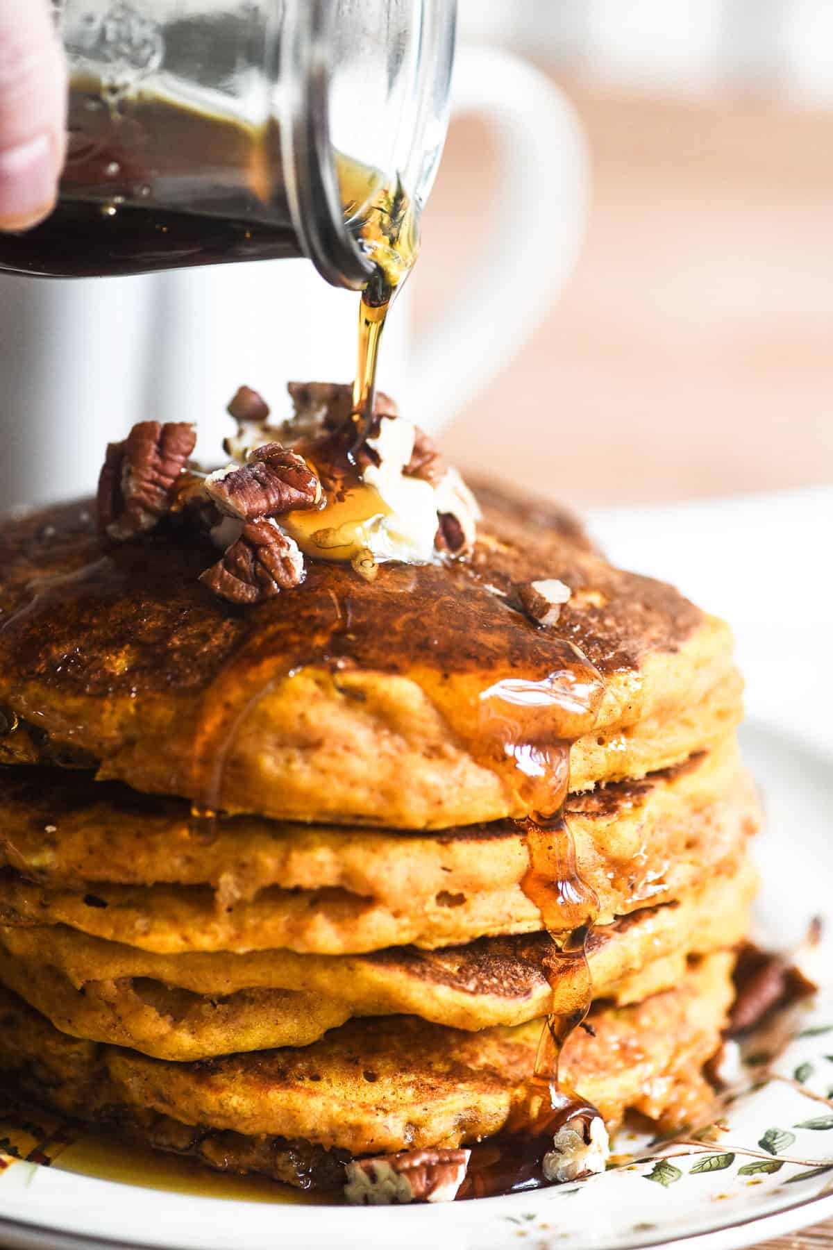 Fluffy pumpkin pancake stack, with fork in a bite.
