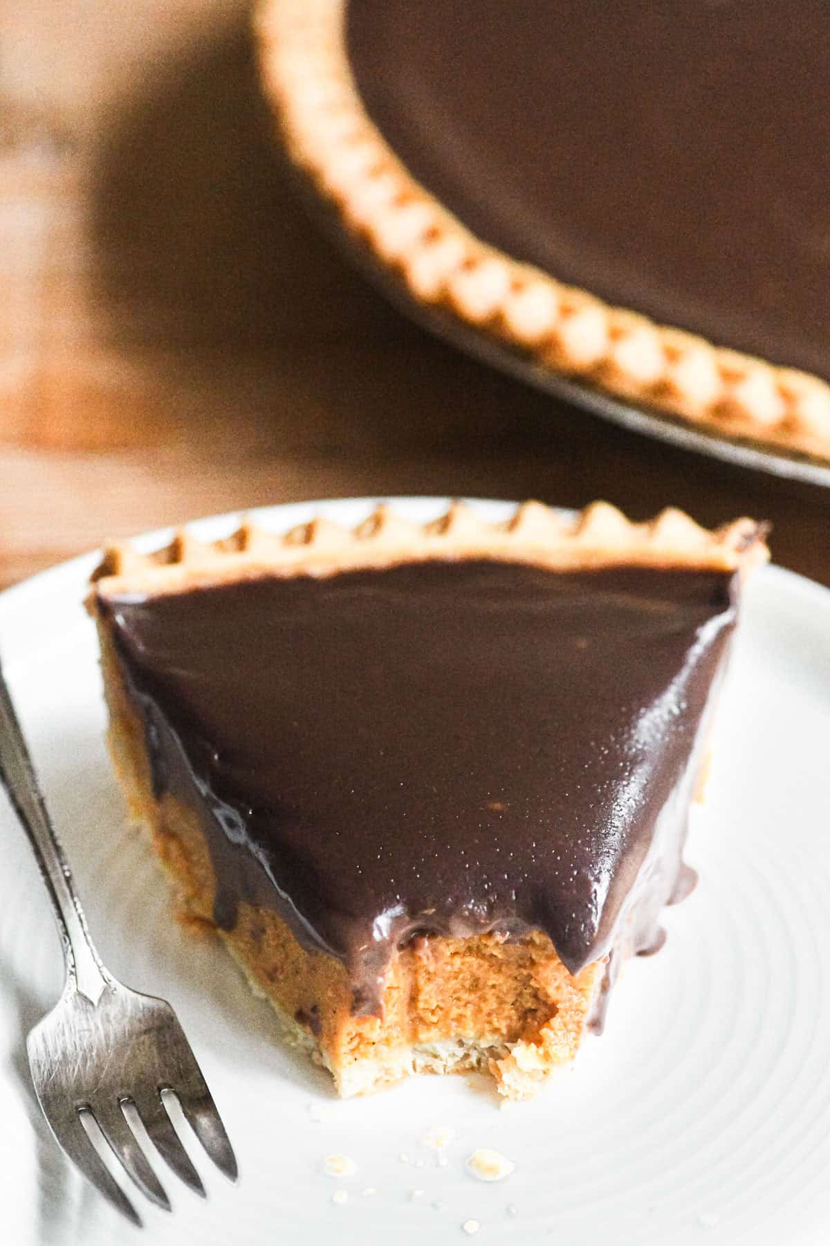 piece of store bought pumpkin pie topped with chocolate ganache.
