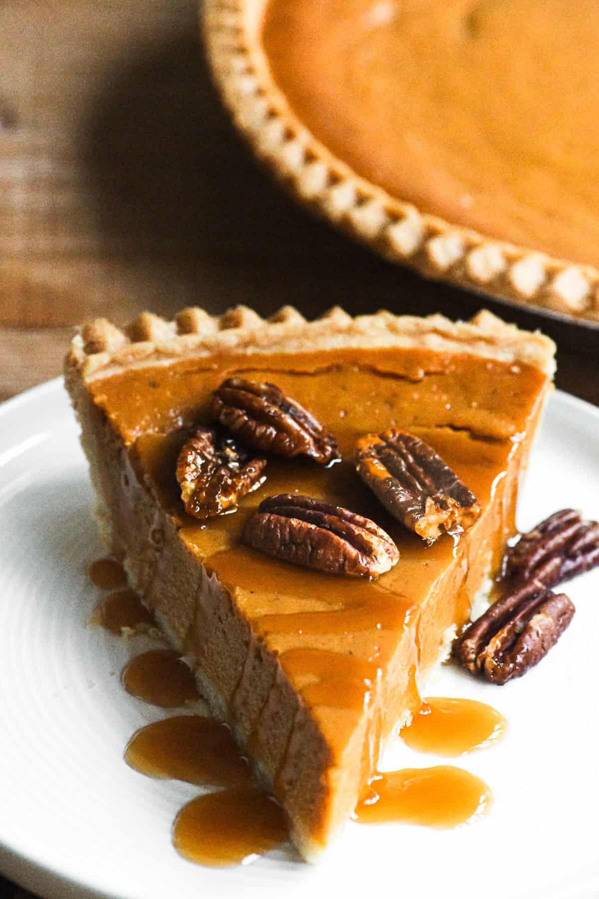 Store bought pumpkin pie drizzled with caramel sauce and topped with candied pecans.