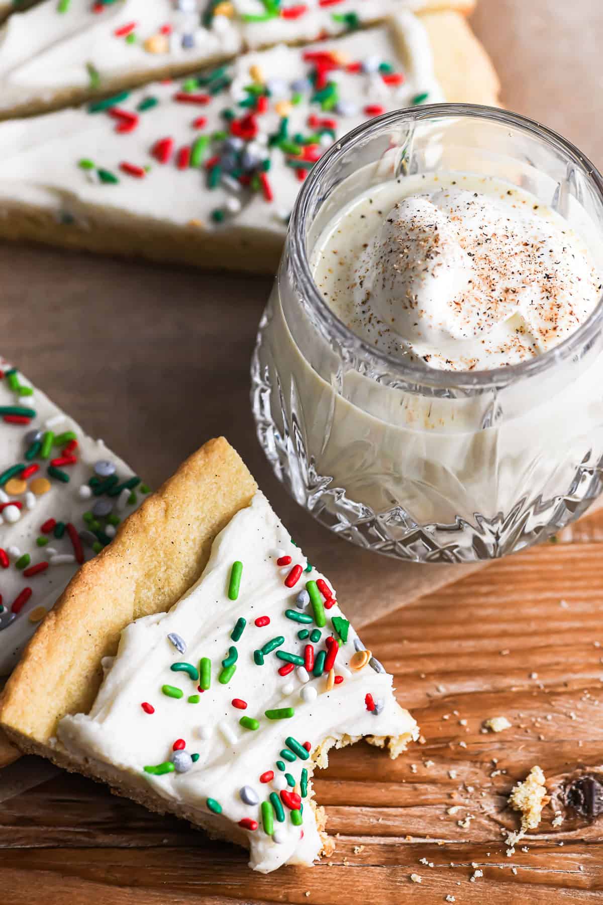 slice of Giant Christmas Cookie Pie with glass of eggnog