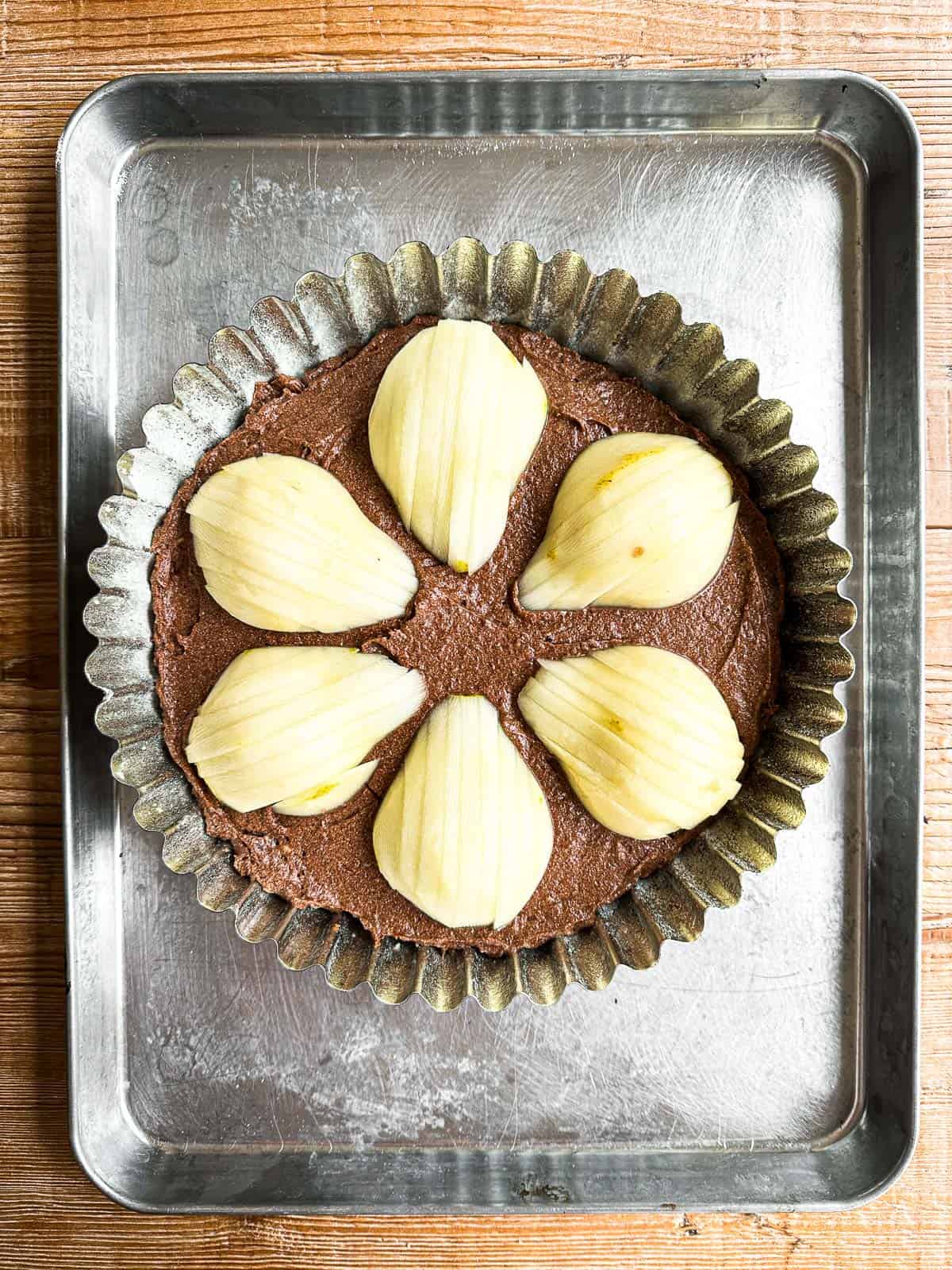 Gluten-Free Chocolate Almond Pear Cake on a baking sheet ready to bake.