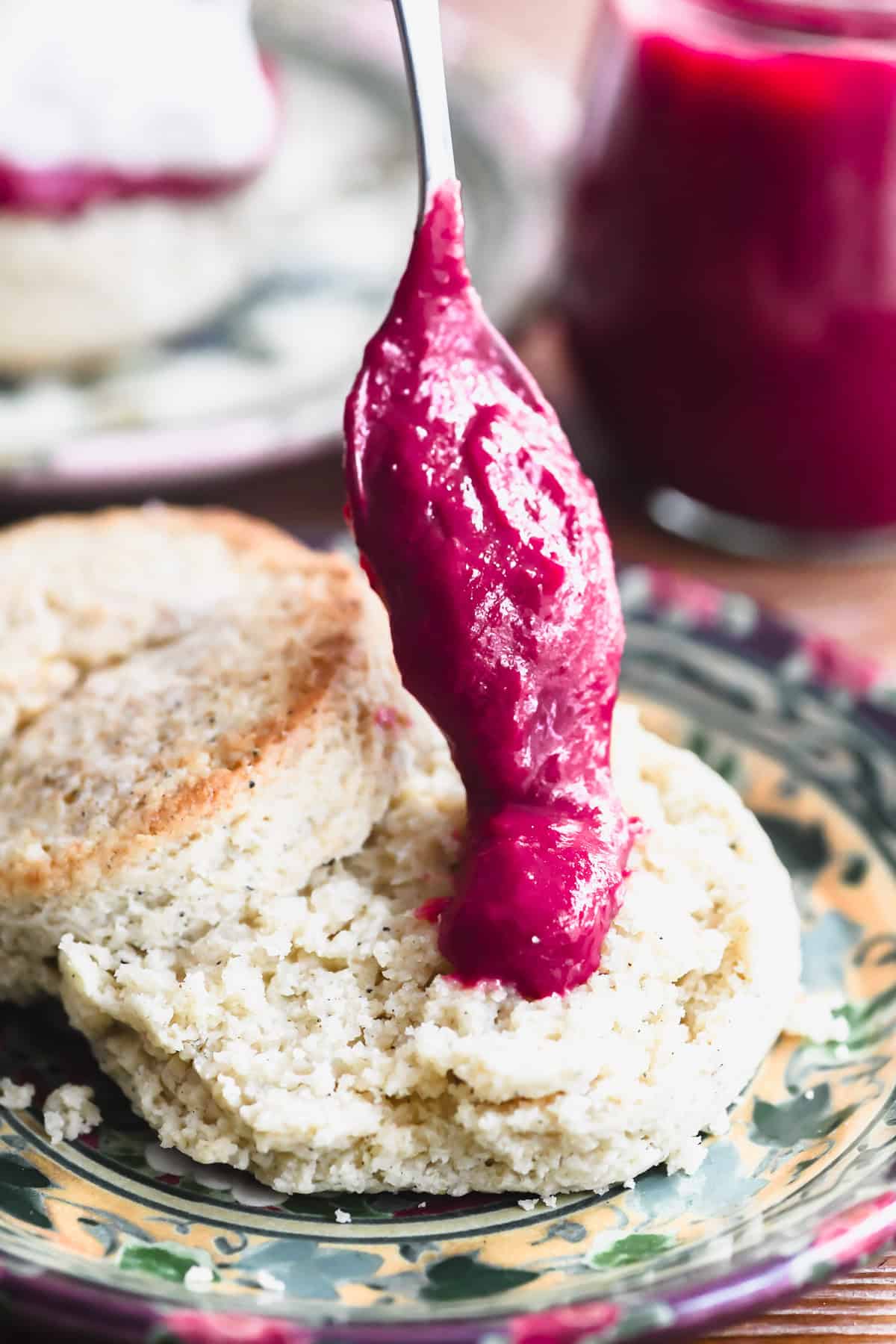 spooning cranberry orange curd onto a scone.